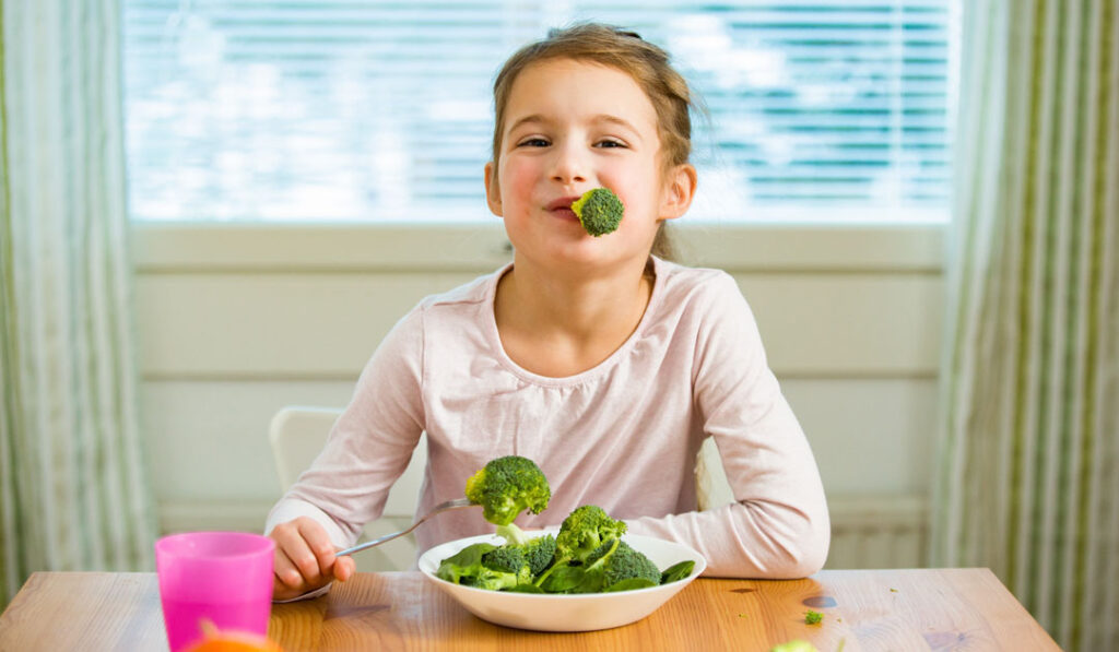 kid eating greens