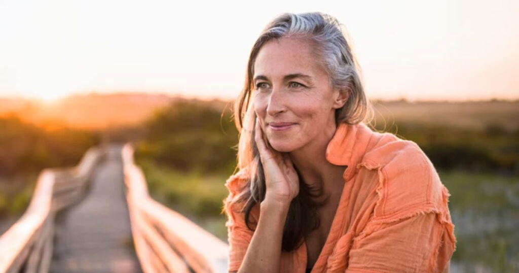 woman waiting on wooden walk-way